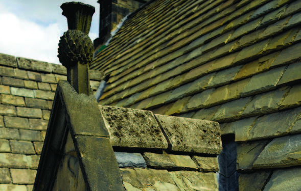 A thistle roof finial above one of Acheson house's dormer window.