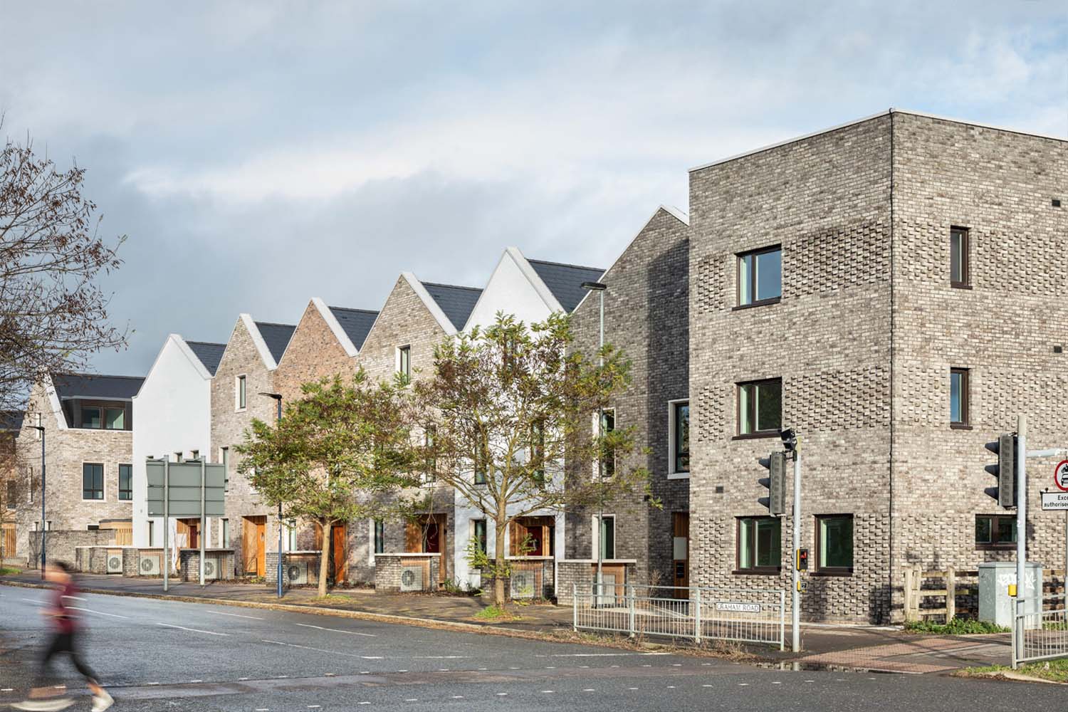 A row of modern terrace tenements/houses in Scotland made of multi-coloured bricks. 