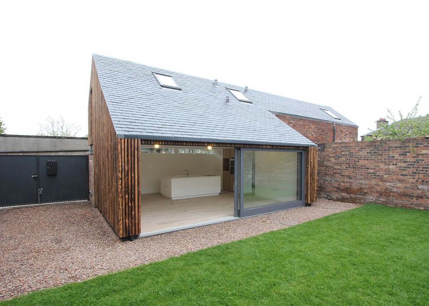 Sliding doors from the House on Rosefield Avenue Lane's kitchen and dining area open into the garden. The roof also has built-in skylights.