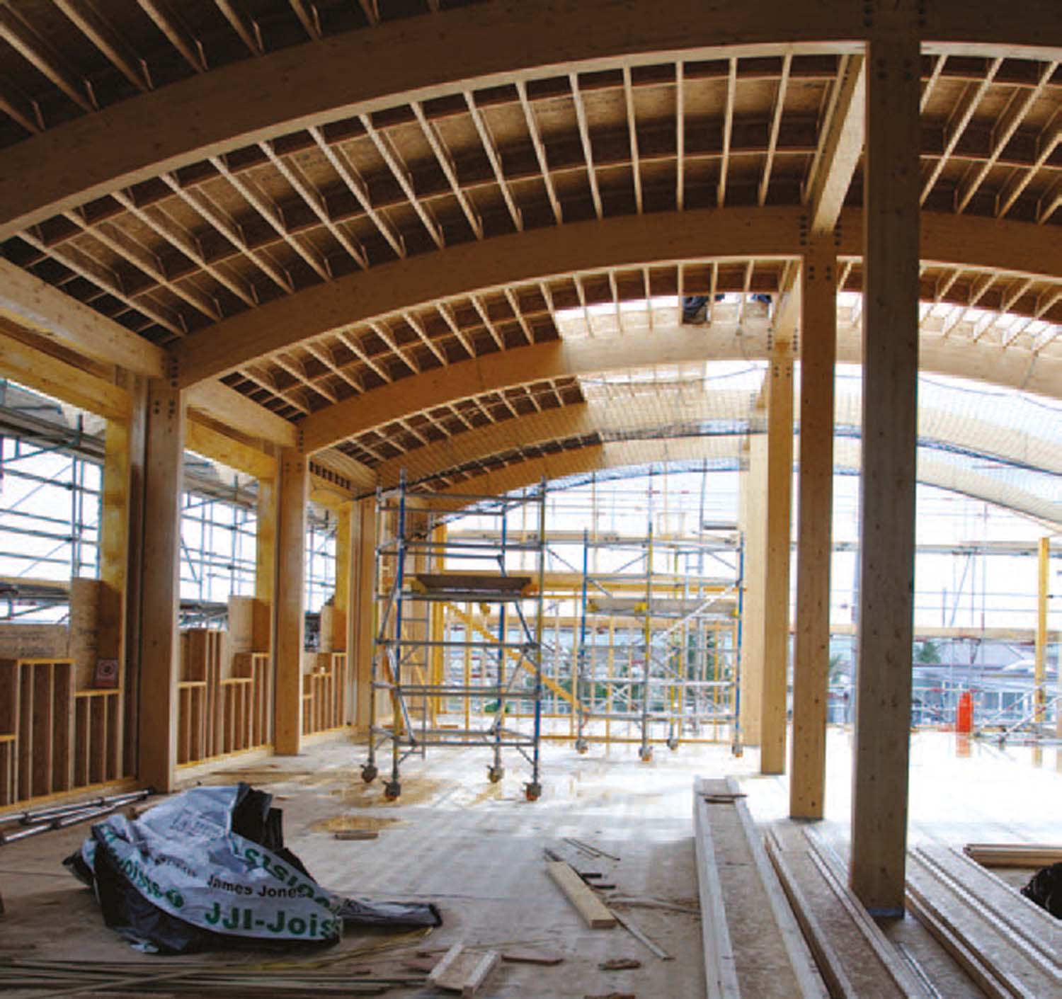 Two large scaffolding on wheels below the curved roof of Thurso College's extension.