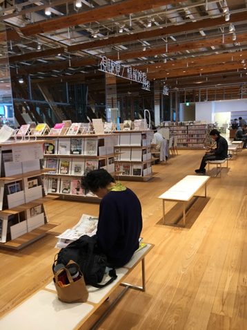 Customers relax on white benches at Toyama's Central Library and Museum.