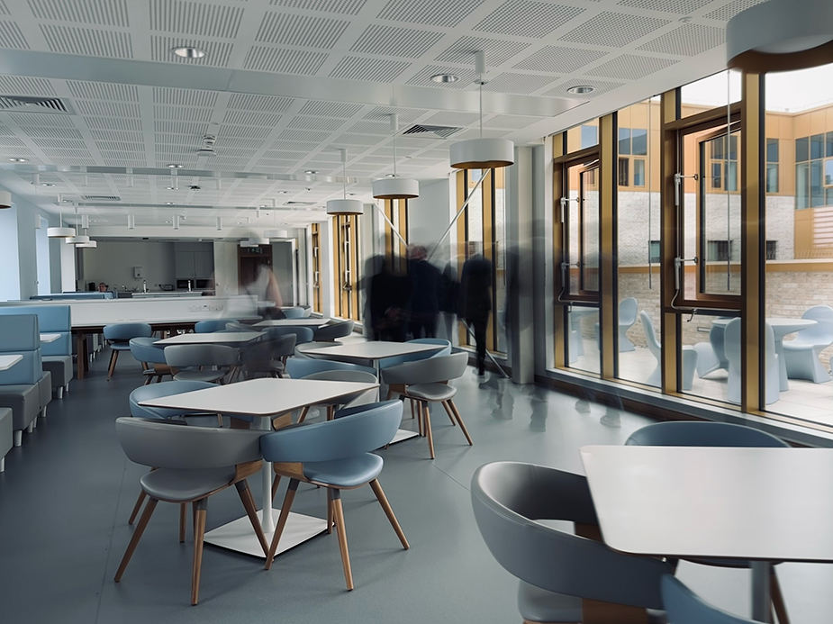 Dining area for staff members of Parkhead Hub with a variety of seating area and floor to celing windows.
