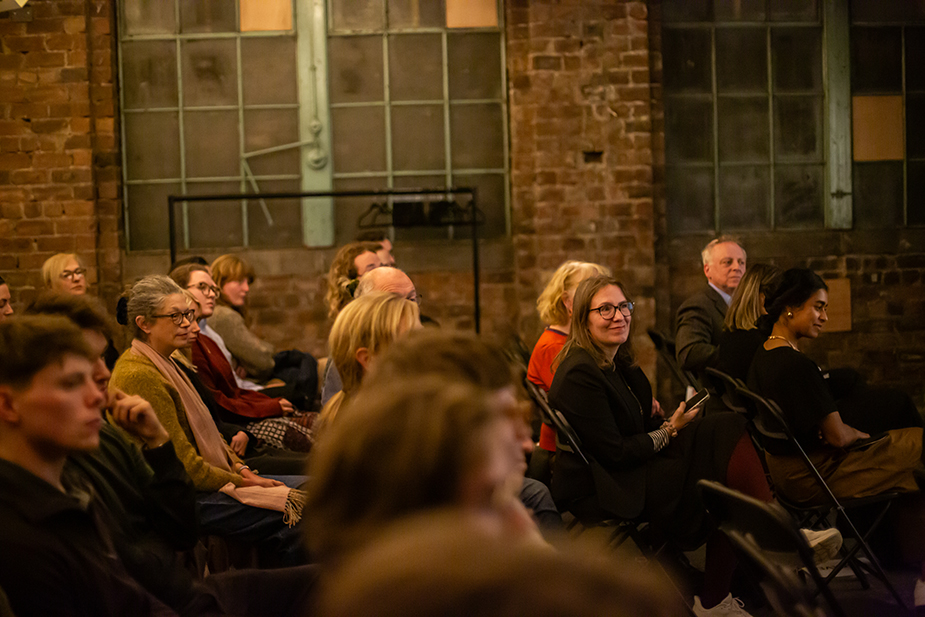 People sat down at an event and looking at the presenter.
